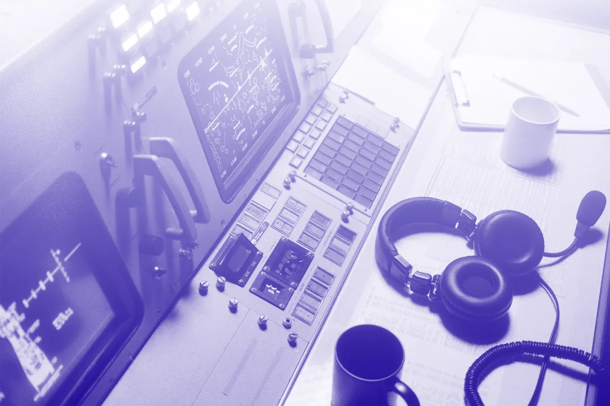 Mission control desk with headset, in Search Theory purple