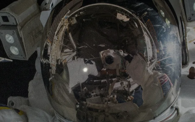 Astronaut helmet reflecting the Earth